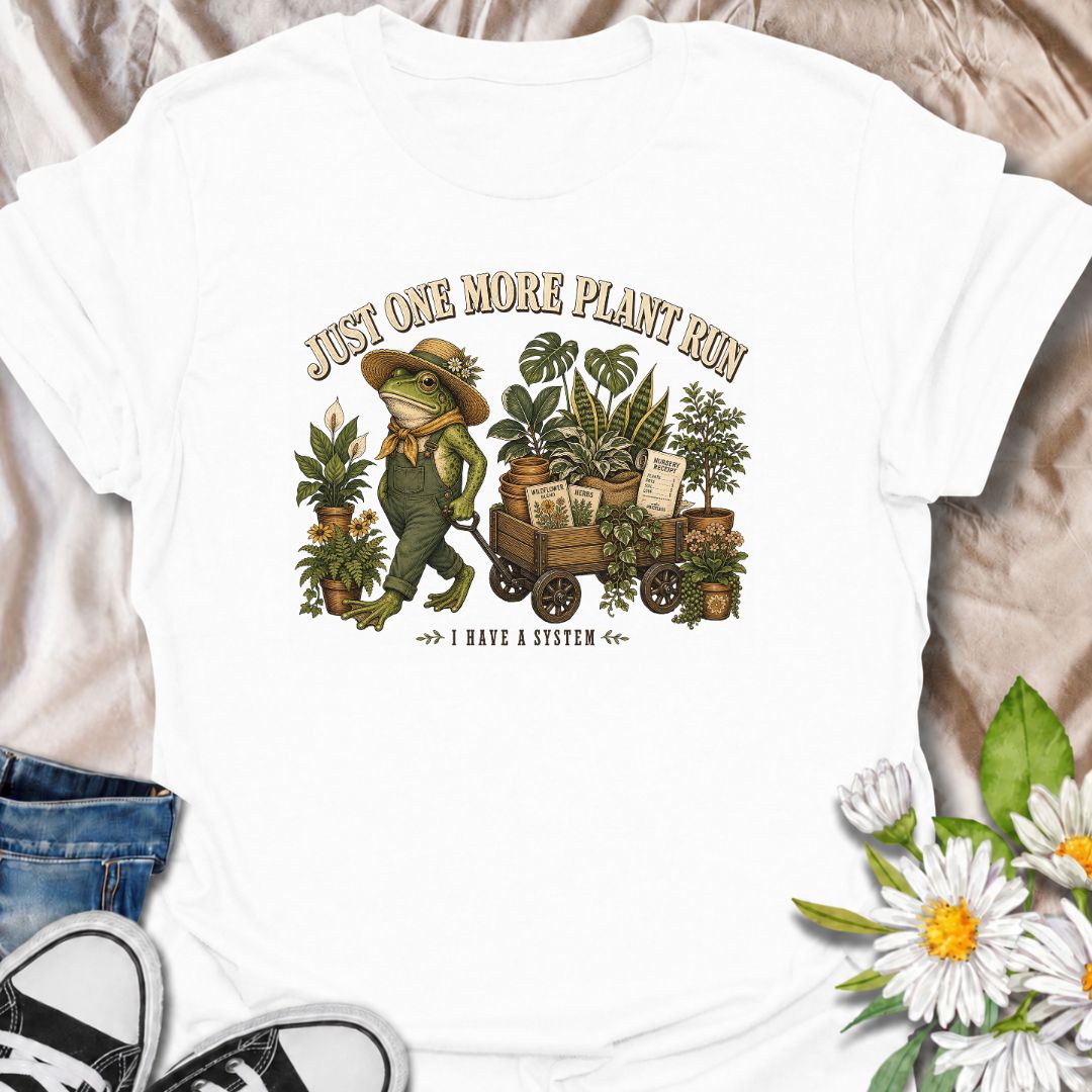 A funny plant-shopping T-shirt featuring a stylish frog and a wagon full of nursery finds. Made for plant lovers who can never buy just one more.