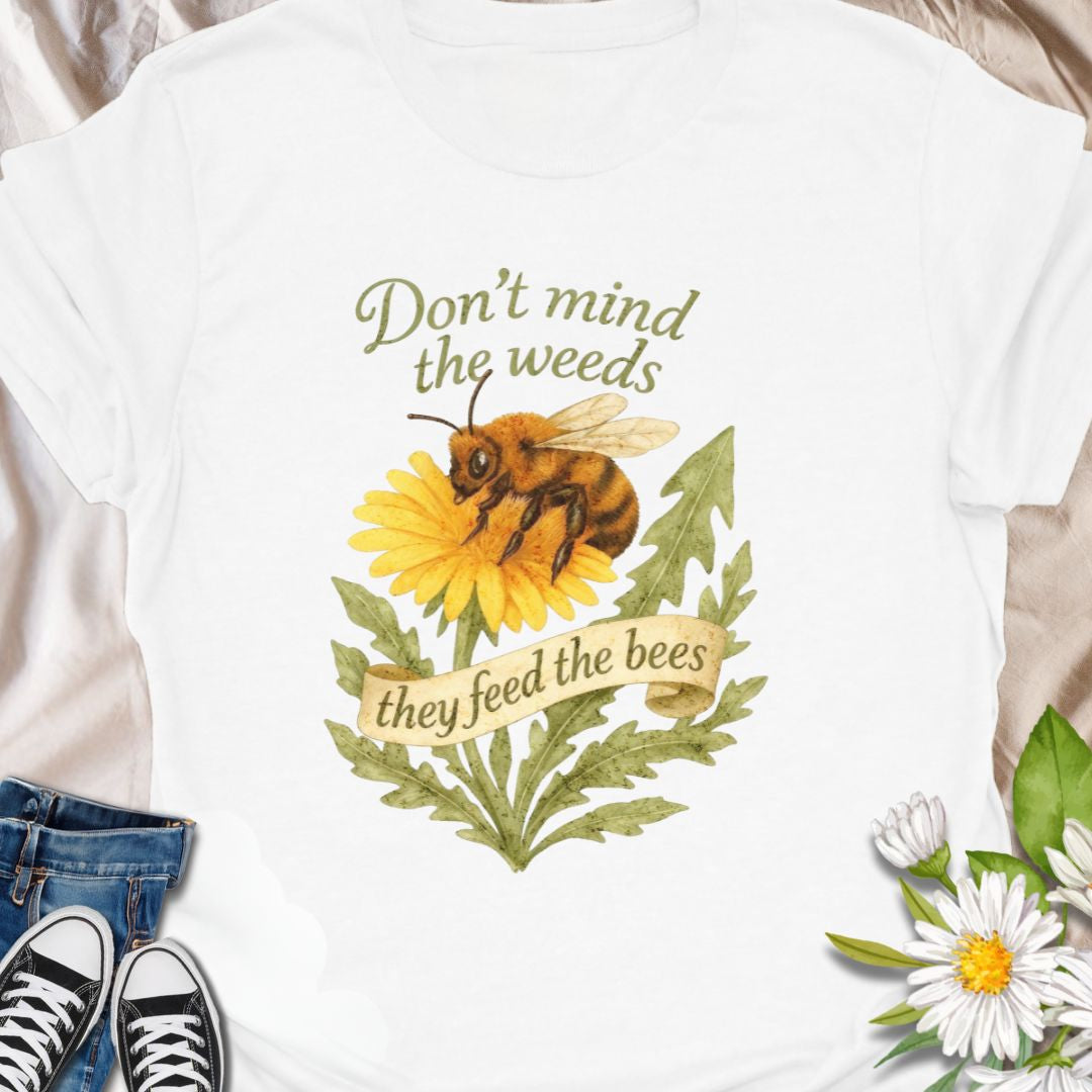 Support pollinators in style with this charming “Don’t Mind the Weeds, They Feed the Bees” t-shirt. Featuring a hand-drawn bee and dandelion artwork, this eco-friendly message tee is perfect for gardeners, nature lovers, and bee advocates who know weeds can be beautiful too.