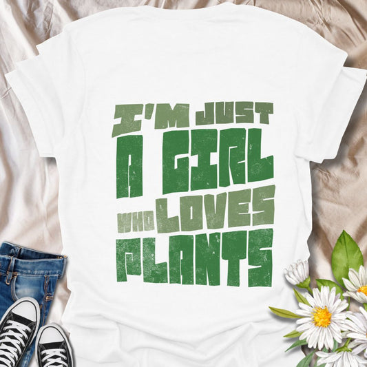 Bold statement t-shirt for plant lovers with the phrase “I’m Just a Girl Who Loves Plants” in rustic green text. Perfect gift for gardeners, plant moms, succulent fans, and nature enthusiasts who adore their indoor jungle or outdoor garden.