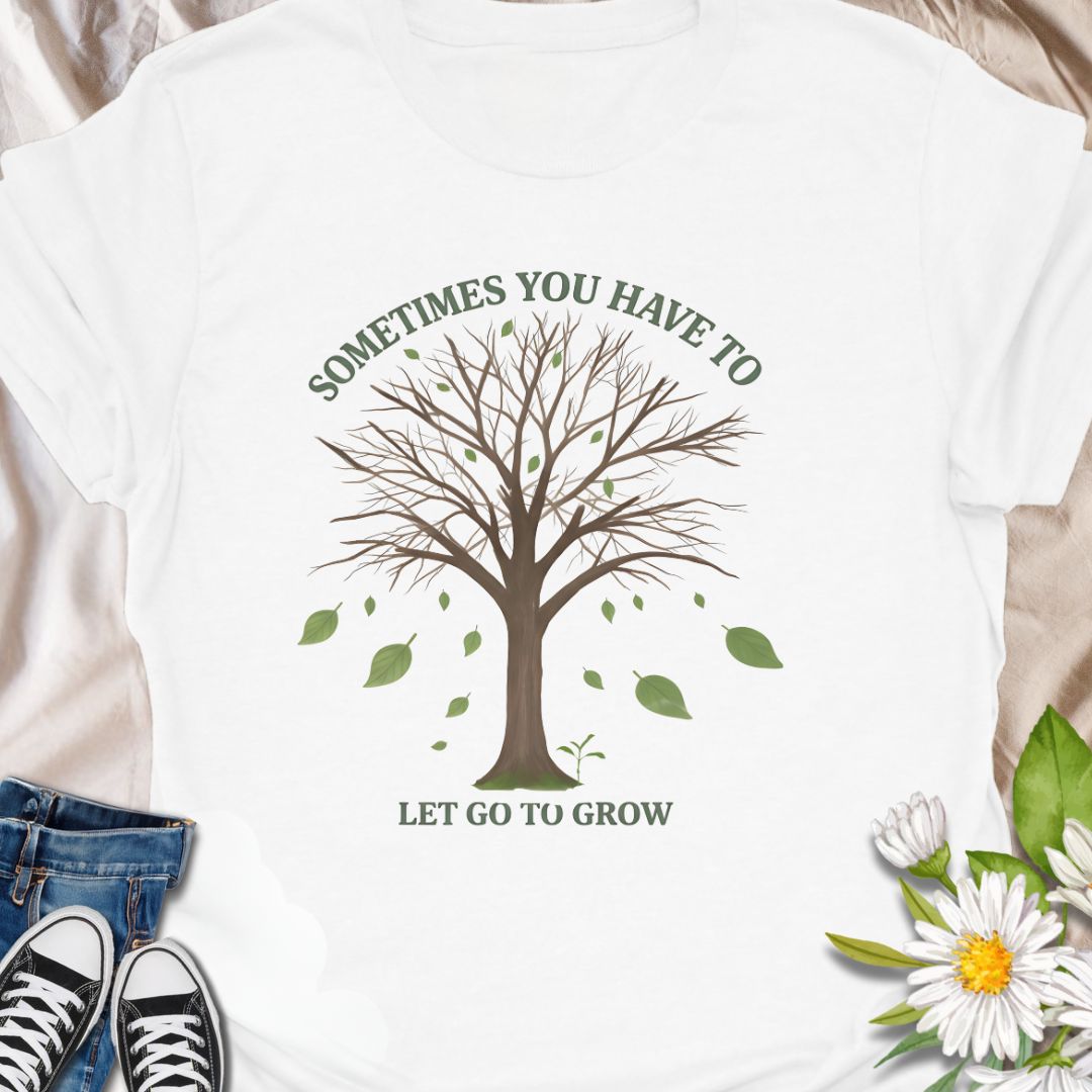 Embrace change and personal growth with this inspirational “Sometimes You Have to Let Go to Grow” t-shirt. Featuring a minimalist tree shedding leaves, this motivational nature-themed design is perfect for anyone navigating transformation, healing, or new beginnings. A thoughtful gift for plant lovers, nature fans, or those on a journey of self-growth.