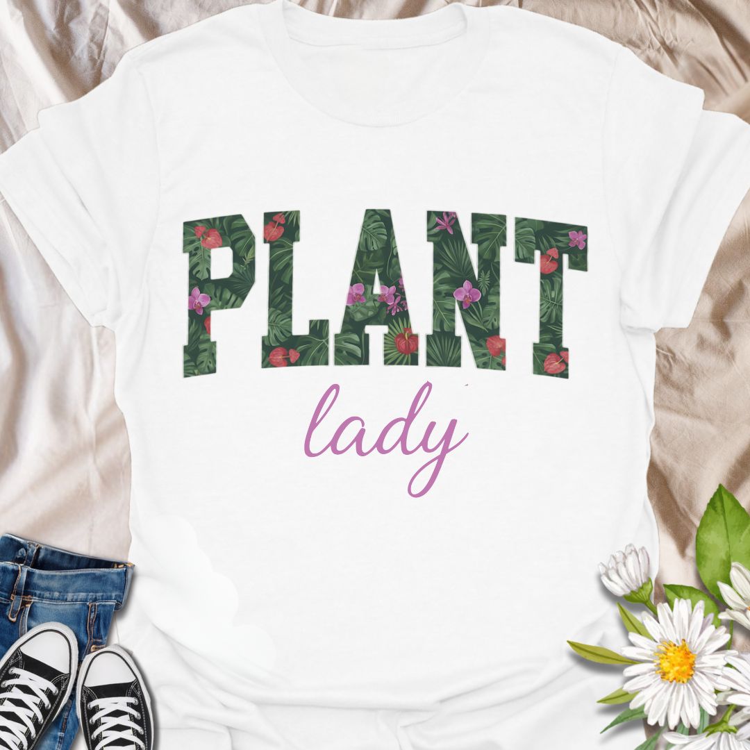 Show off your green thumb in style with this vibrant “Plant Lady” graphic t-shirt featuring bold botanical lettering and a feminine touch. Perfect for plant moms, garden lovers, and anyone who proudly embraces their love for all things leafy and green.