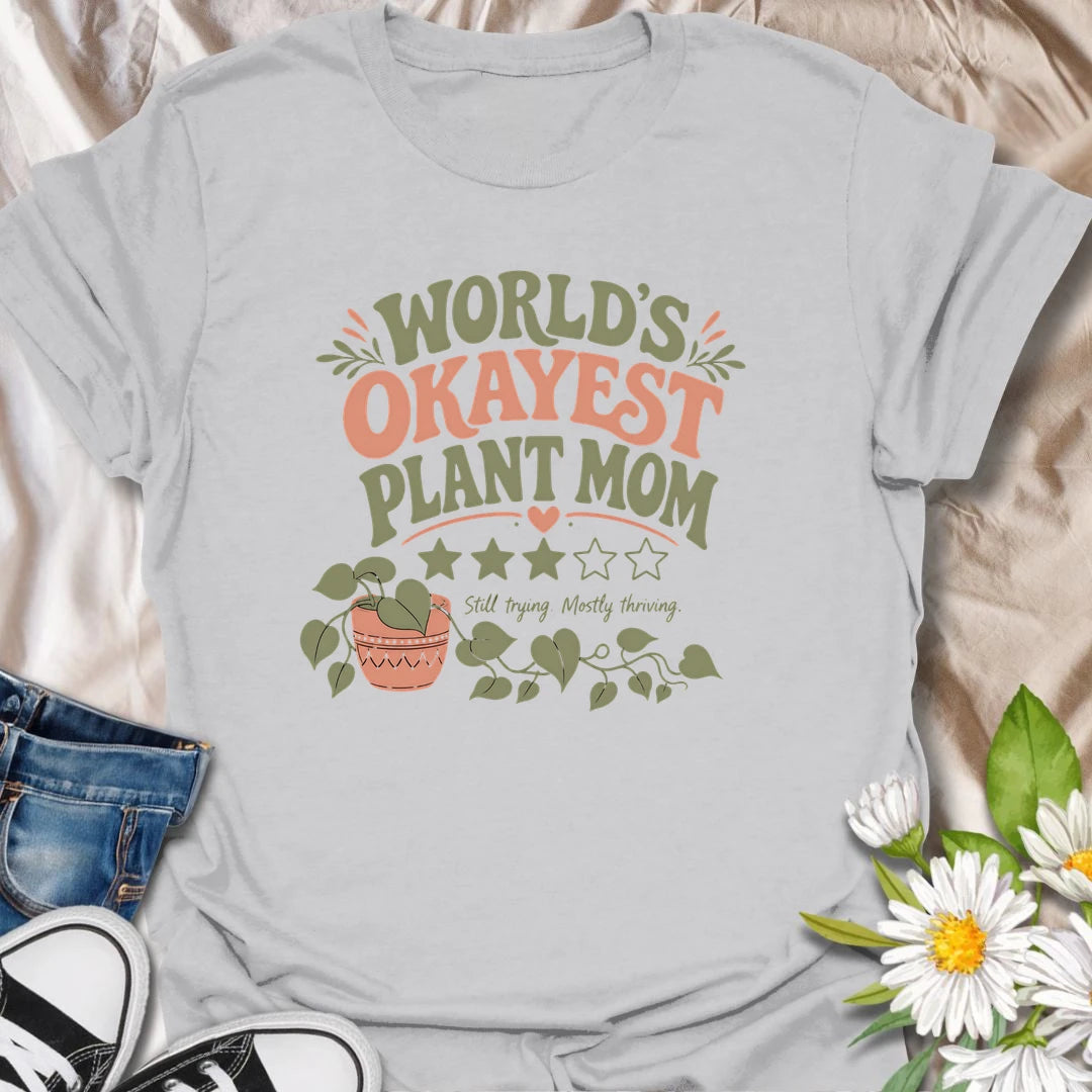 Celebrate imperfect plant parenting with this funny “World’s Okayest Plant Mom” T-shirt. Featuring a playful three-star rating, trailing houseplant, and the phrase “Still Trying, Mostly Thriving,” it is perfect for plant lovers who do their best without taking plant care too seriously. A fun gift for houseplant moms, indoor gardeners, and proudly average green thumbs.