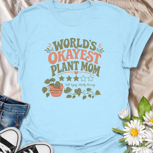 Celebrate imperfect plant parenting with this funny “World’s Okayest Plant Mom” T-shirt. Featuring a playful three-star rating, trailing houseplant, and the phrase “Still Trying, Mostly Thriving,” it is perfect for plant lovers who do their best without taking plant care too seriously. A fun gift for houseplant moms, indoor gardeners, and proudly average green thumbs.