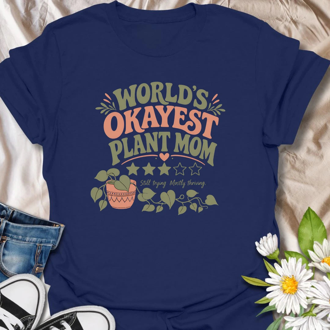Celebrate imperfect plant parenting with this funny “World’s Okayest Plant Mom” T-shirt. Featuring a playful three-star rating, trailing houseplant, and the phrase “Still Trying, Mostly Thriving,” it is perfect for plant lovers who do their best without taking plant care too seriously. A fun gift for houseplant moms, indoor gardeners, and proudly average green thumbs.