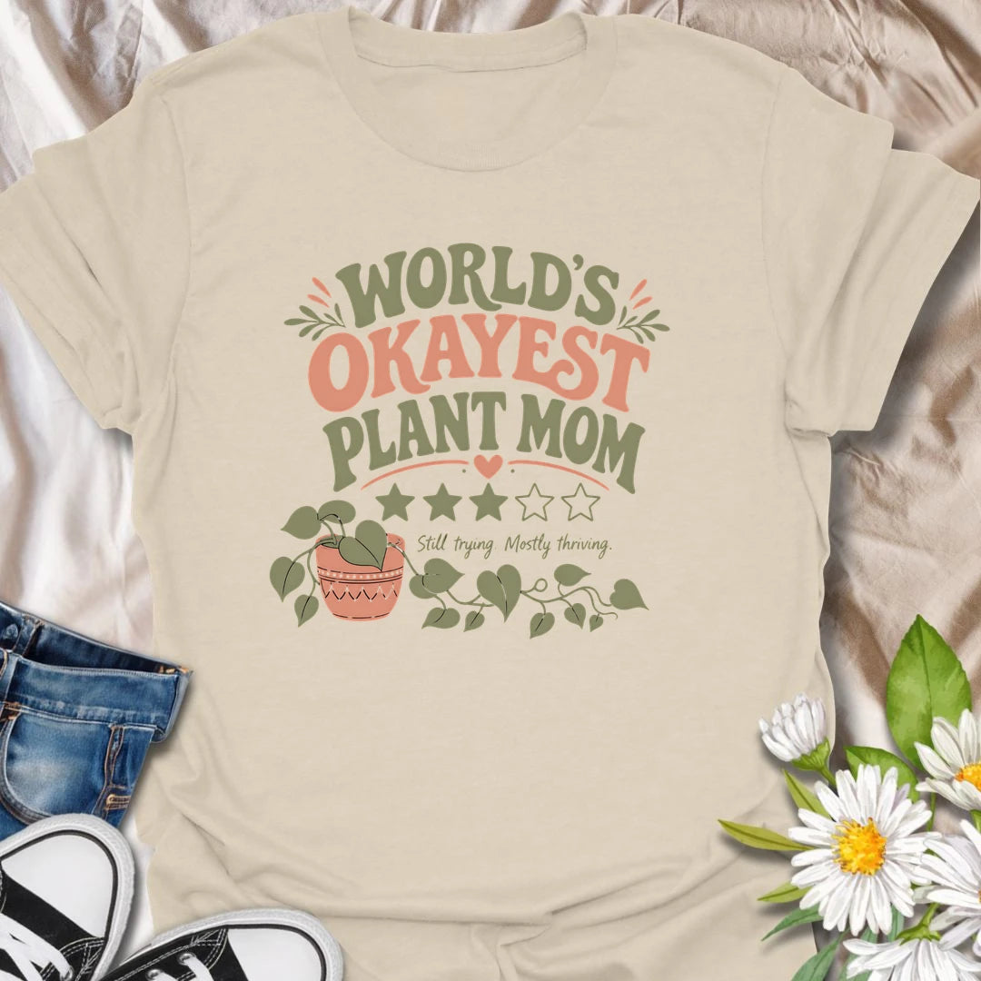 Celebrate imperfect plant parenting with this funny “World’s Okayest Plant Mom” T-shirt. Featuring a playful three-star rating, trailing houseplant, and the phrase “Still Trying, Mostly Thriving,” it is perfect for plant lovers who do their best without taking plant care too seriously. A fun gift for houseplant moms, indoor gardeners, and proudly average green thumbs.